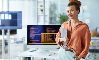 Female young programmer working at office