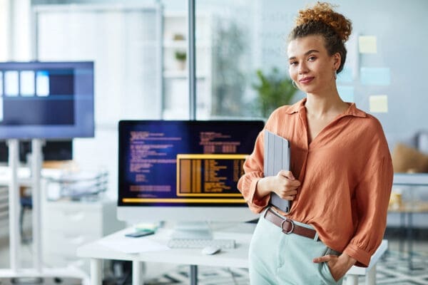 Female young programmer working at office