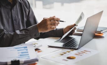 Businessman working with business report papers on office desk